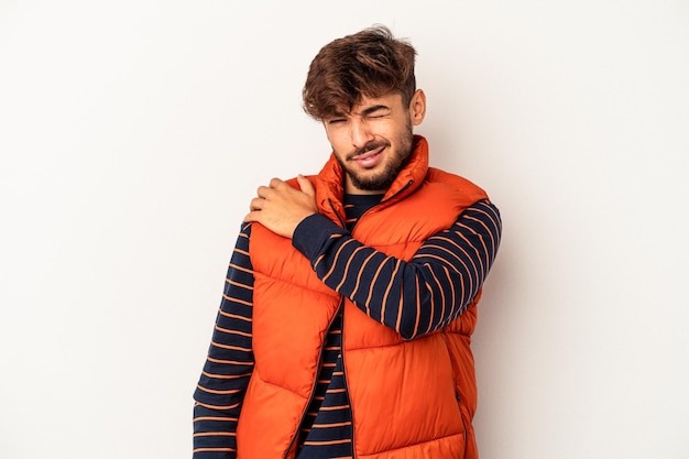 Young mixed race man isolated on grey background having a shoulder pain.