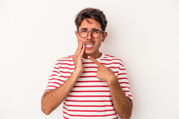 Young mixed race man isolated on white background having a strong teeth pain, molar ache.