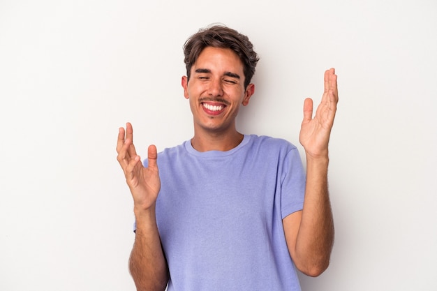 Young mixed race man isolated on white background joyful laughing a lot. Happiness concept.