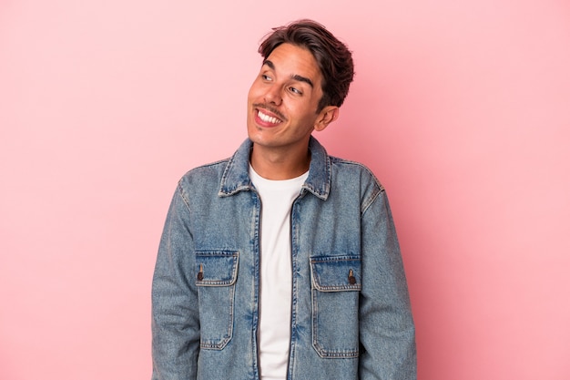 Young mixed race man isolated on white background laughs and closes eyes, feels relaxed and happy.