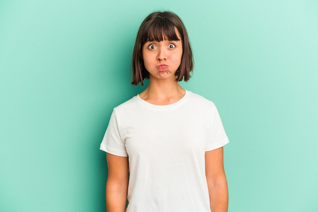 Young mixed race woman isolated on blue background unhappy looking in camera with sarcastic expression.