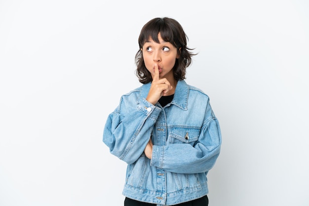 Young mixed race woman isolated on white background showing a sign of silence gesture putting finger in mouth