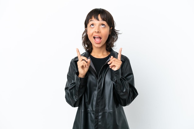 Young mixed race woman isolated on white background surprised and pointing up