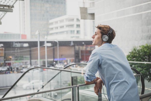 young model hansome blonde man with headphones