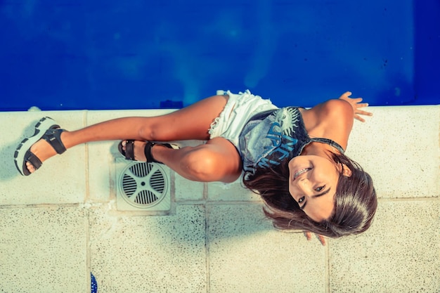 Young model posing in a swimming pool