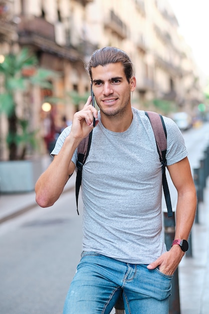 Young model with backpack using smarphone