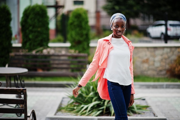 Young modern fashionable attractive tall and slim african muslim woman in hijab or turban head scarf posed