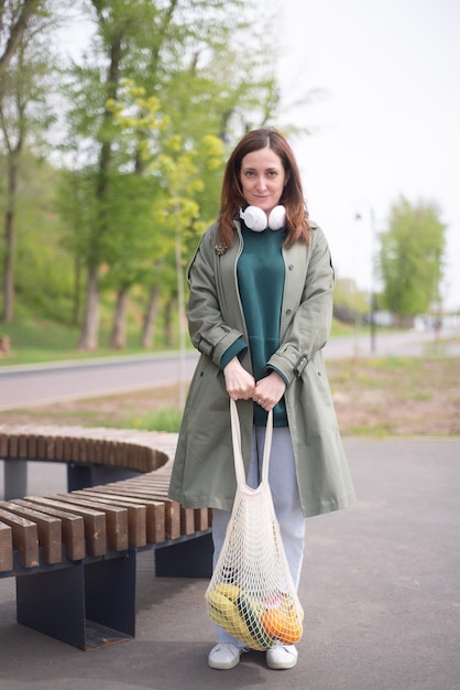 A young modern girl holding an eco bag with products