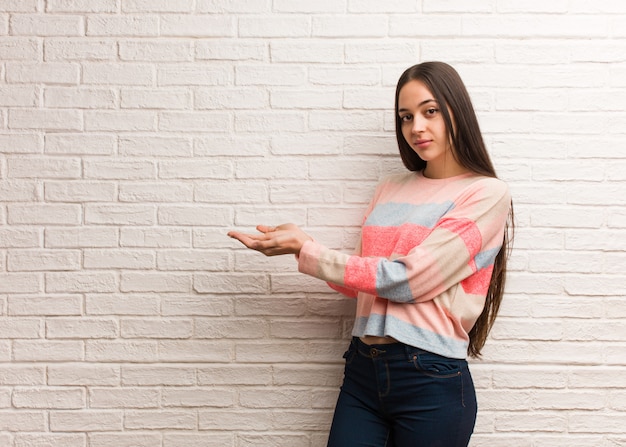 Young modern woman holding something with hands