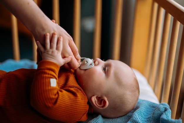 Young mom gives baby a pacifier 5 months Toddler