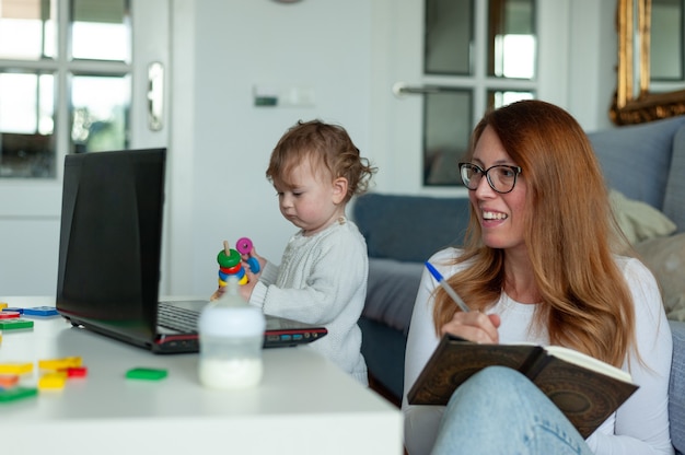 Young mom working from home with baby