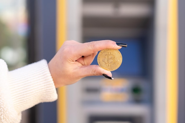 Young moroccan girl at outdoors using an ATM