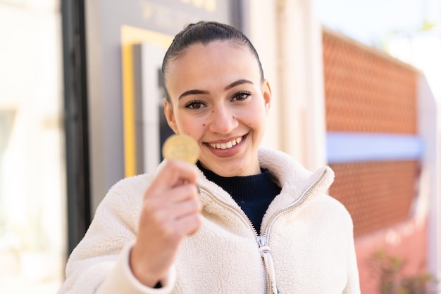 Young moroccan girl at outdoors with happy expression