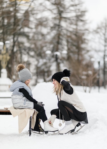 Young mother and daughter in snow 15