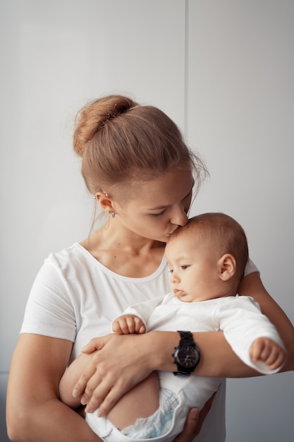 Young mother have fun with her baby at home