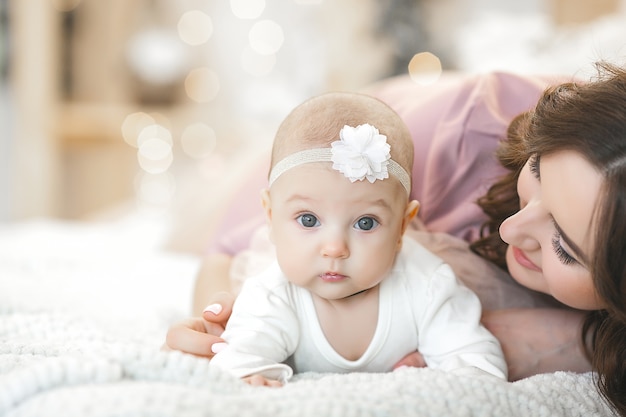 young mother holding her cute little babygirl.