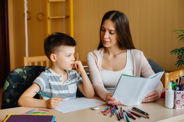 young mother is doing homework with her sont home