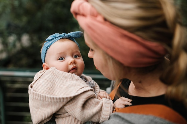 Young mother looking down at her baby girl