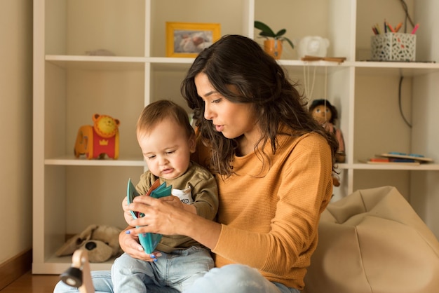 Young Mother playing with toddler at home