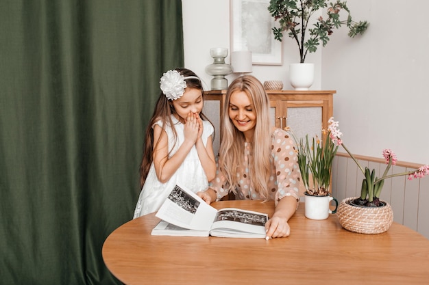 Young mother reads an interesting book for her small daughter