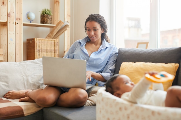 Young Mother Using Laptop