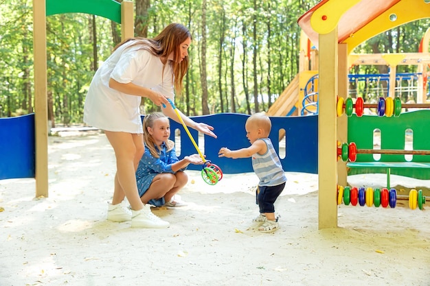 Young mother with children on the playground