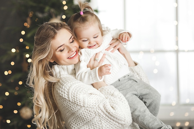 young mother with her little baby with christmas decoration