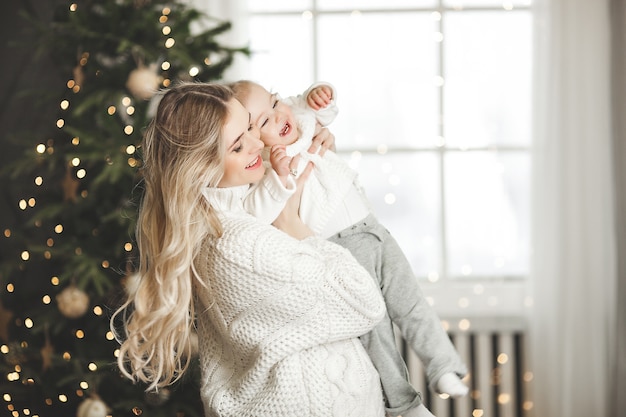 young mother with her little baby with christmas decoration