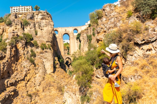 A young mother with her son at the new bridge viewpoint in Ronda Malaga province Andalucia