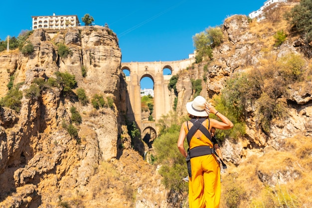 A young mother with her son visiting the new bridge viewpoint in Ronda Malaga province Andalucia