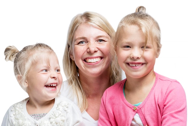 A young mother with two little daughters are hugging and laughing Love and tenderness Isolated on white background