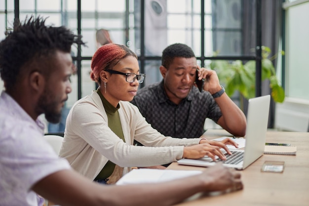 Young motivated and experienced employees are brainstorming in the conference room