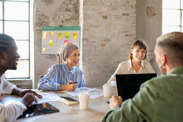 Young multiracial team of creative colleagues working in a open space muslim business woman with her teamwork of creative and fashion designer brainstorming of happy people in office