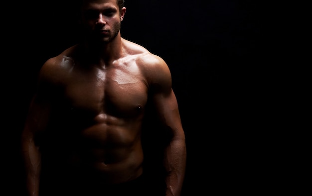 Young muscular fit sportsman posing shirtless