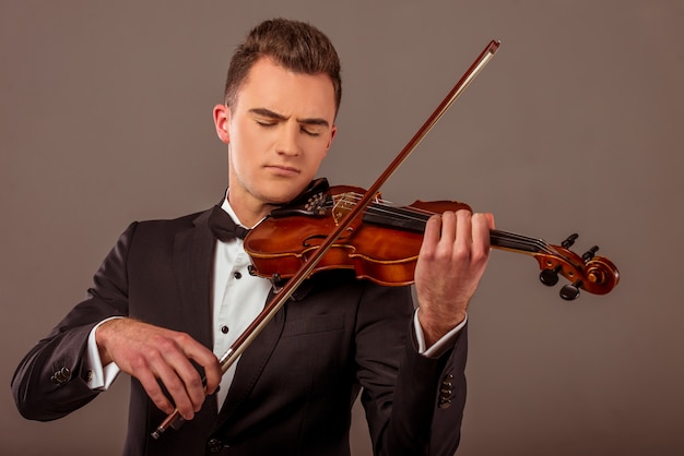 The young musician man playing violin