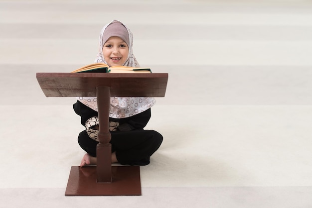 Young Muslim Girl Reading The Koran