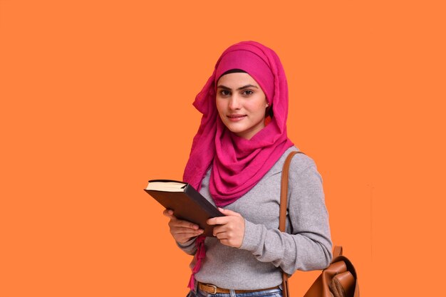 young muslim girl wearing  hijab and holding book indian pakistani model