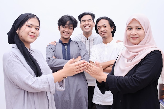 Young muslim people hand shaking, asking for apologize during eid mubarak moment.