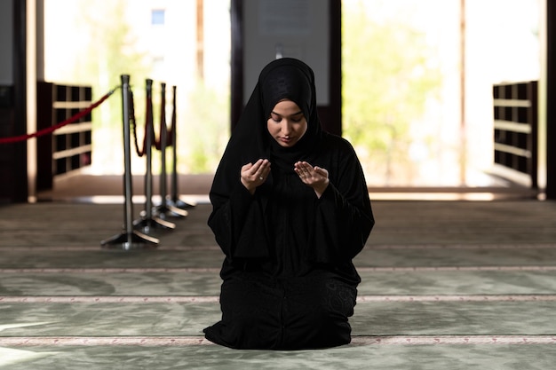 Young Muslim Woman is Praying in the Mosque