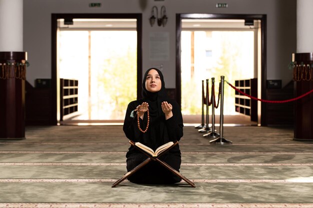 Young Muslim Woman is Praying in the Mosque