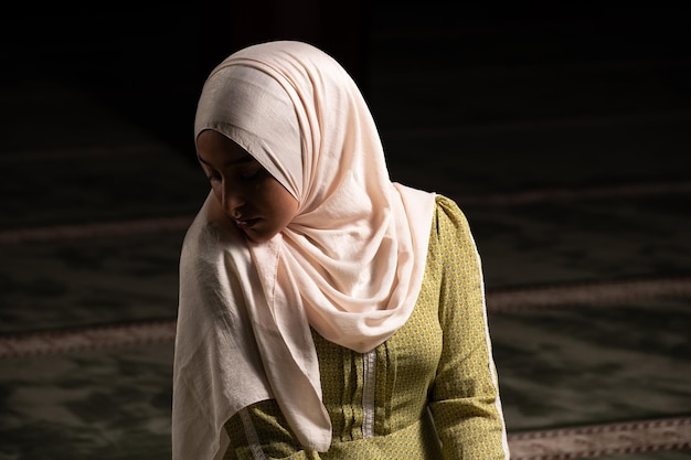 Young Muslim Woman is Praying in the Mosque