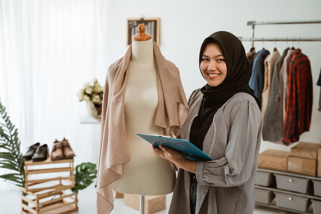 Young Muslim woman with a hijab working