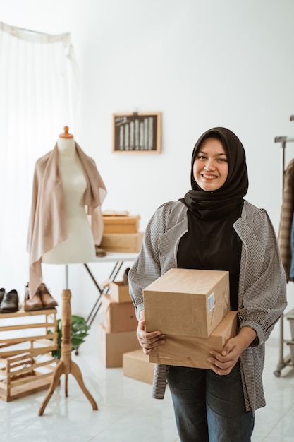 Young Muslim woman with a hijab working