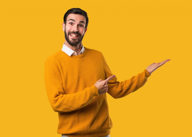 Young natural man holding something with hand