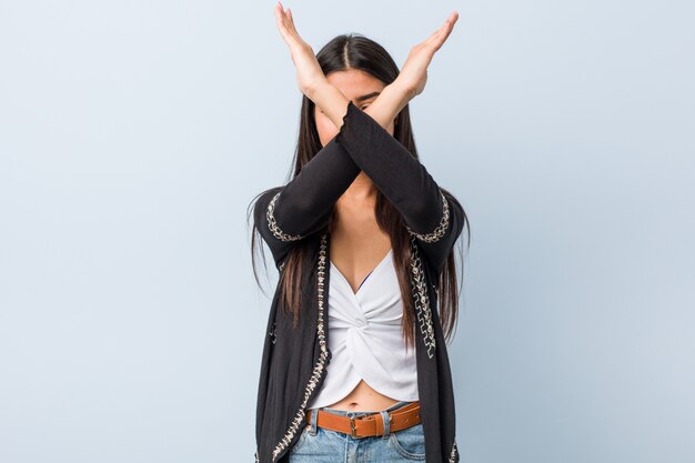 Young natural and pretty arab woman keeping two arms crossed, denial concept.