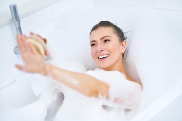 Young nice brunette woman having bath in bathtub High quality photo