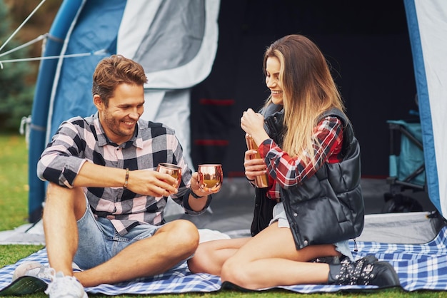 Young nice couple having fun on camping. High quality photo