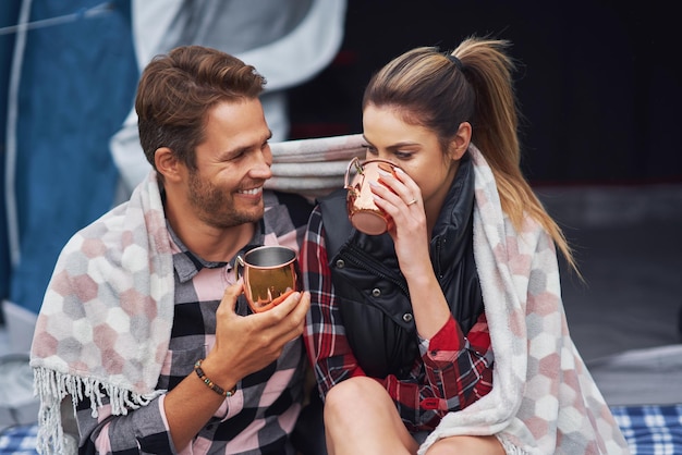 Young nice couple having fun on camping. High quality photo