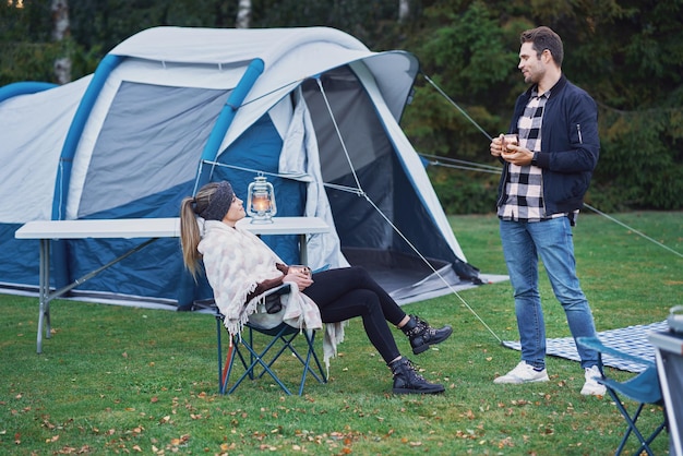 Young nice couple having fun on camping. High quality photo