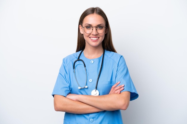 Young nurse caucasian woman isolated on white background keeping the arms crossed in frontal position